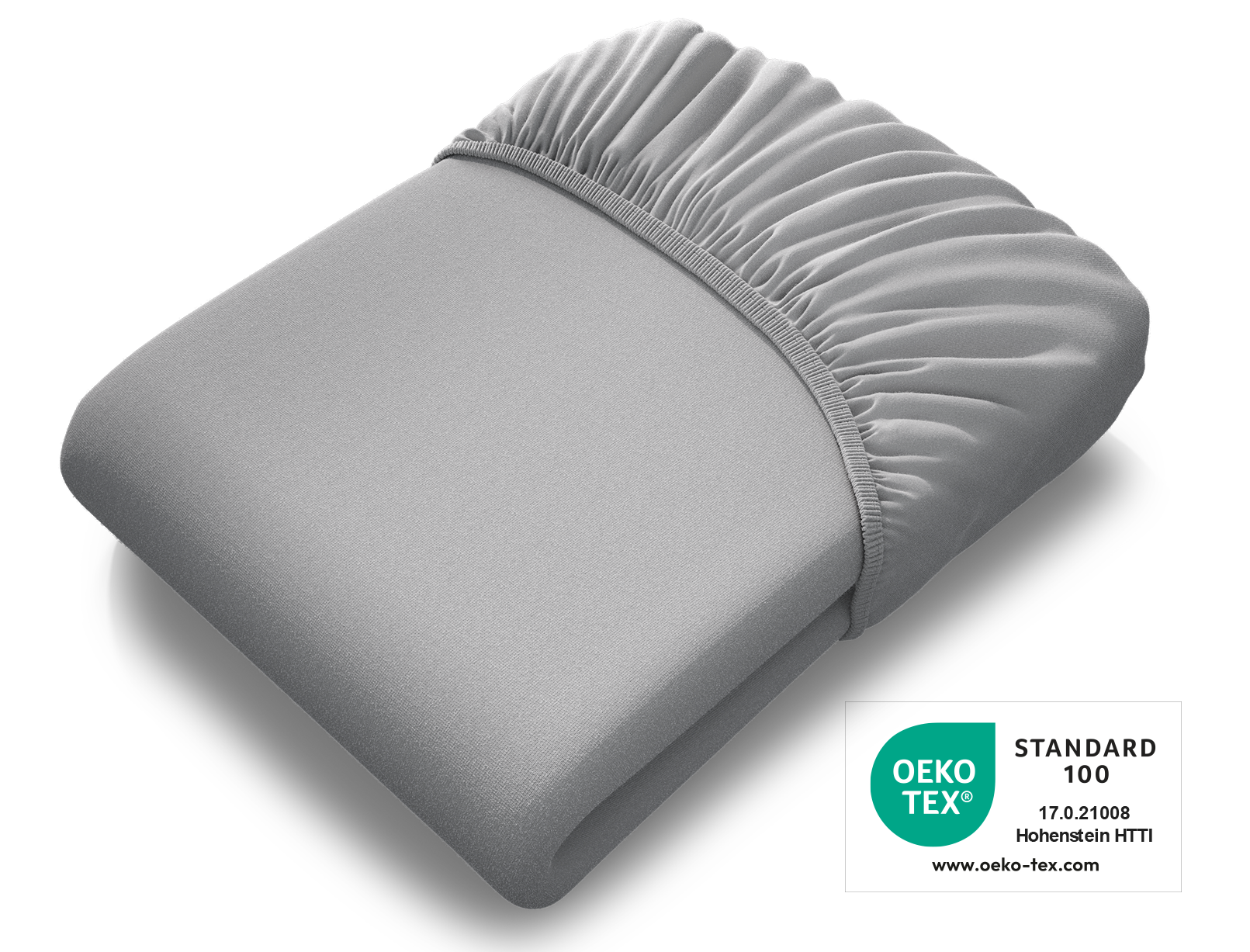 Das BODYGUARD® Spannbettlaken extra hoch zusammengelegt, darüber das Oeko-Tex® Standard 100 Siegel	